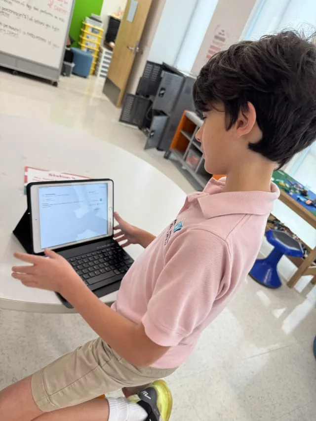 boy uses tablet in classroom