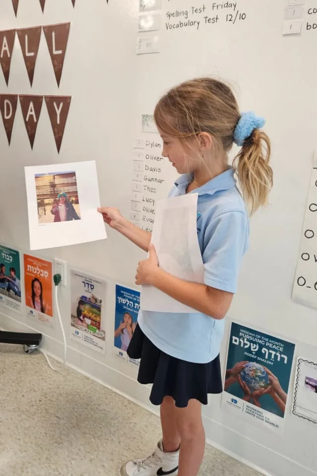 girl shows image of her with flat stanley