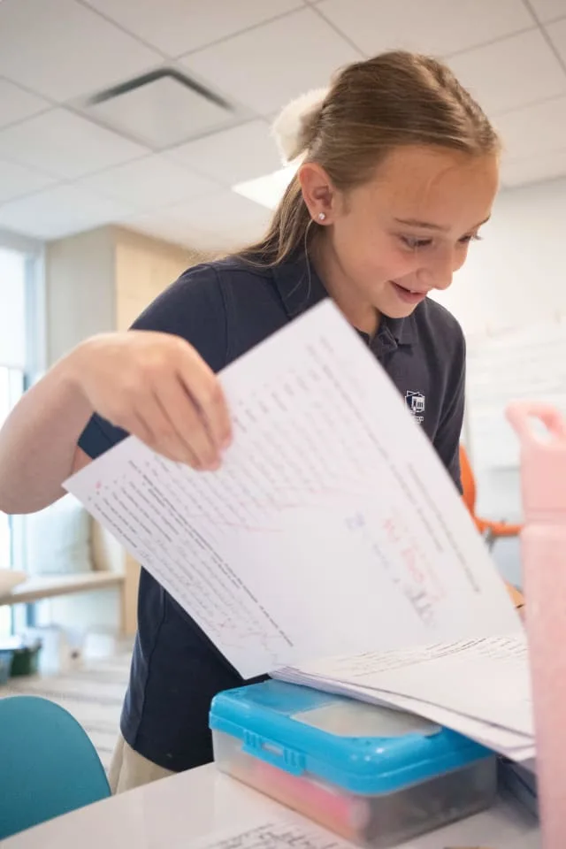 girl completes schoolwork