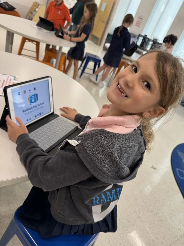girl using tablet in classroom