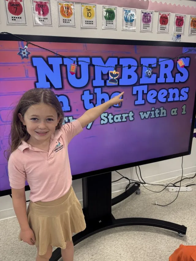 girl points to digital board about Numbers