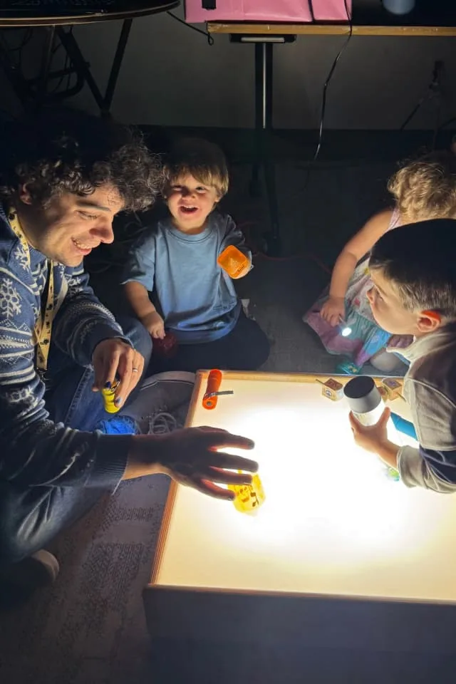 kids play with dreidel on light table