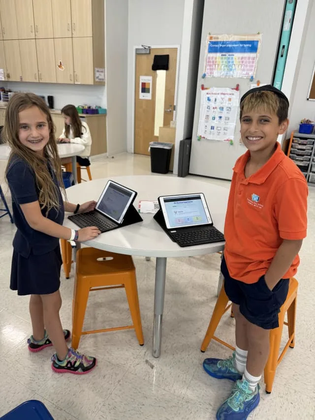 students work on tablets in classroom