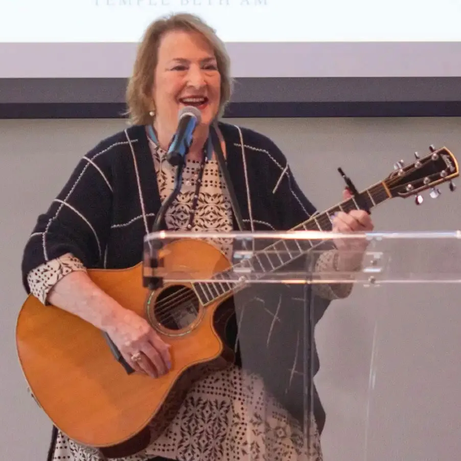 Jackie Berney singing and playing guitar